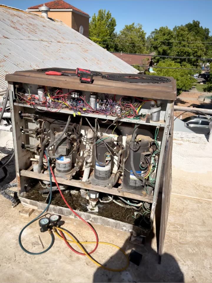 Water-cooled commercial AC condenser with three compressors mid-diagnosis.