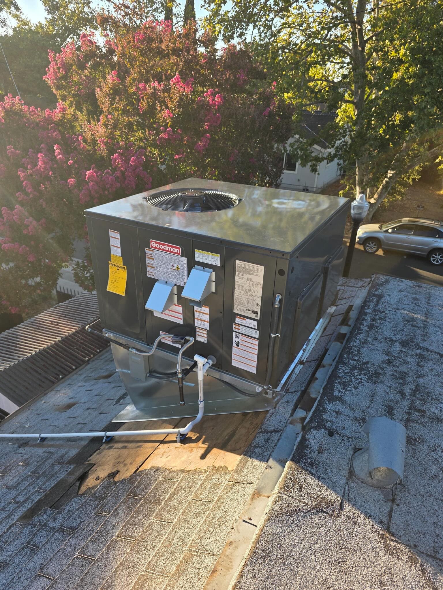Goodman 2.5-ton gas package unit installed with new curb, plenums, and disconnect.