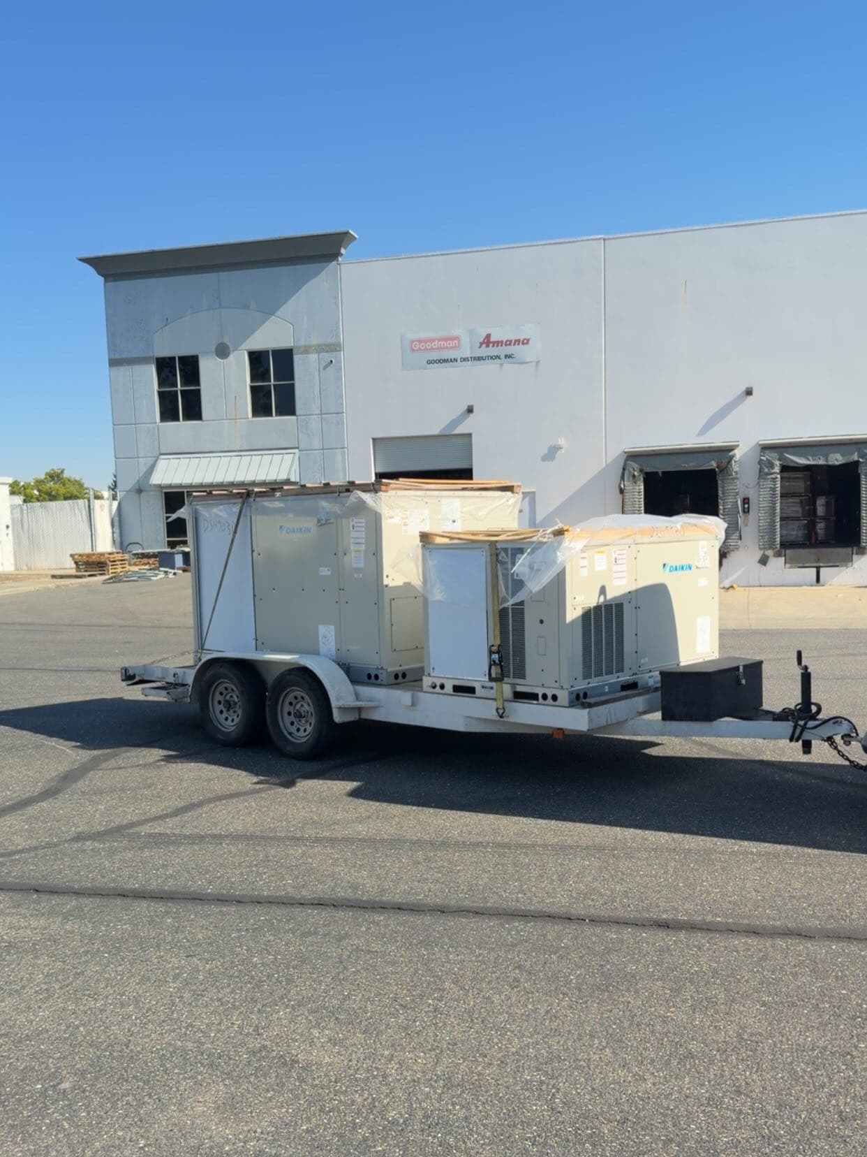 Commercial 3-phase heat pump package units (7.5-ton and 5-ton) during installation.